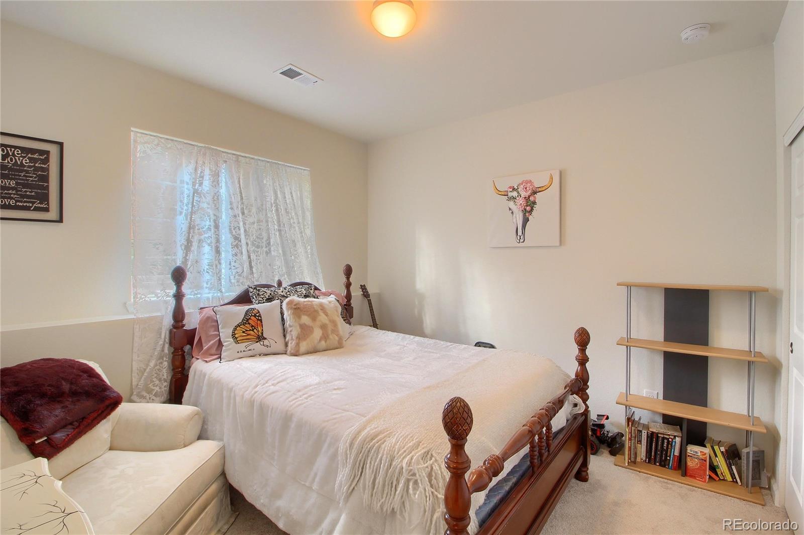 1335 South Chambers Road, Unit 101 Aurora, CO 80017 - Photo 27 of 40 a bedroom with bed and a window