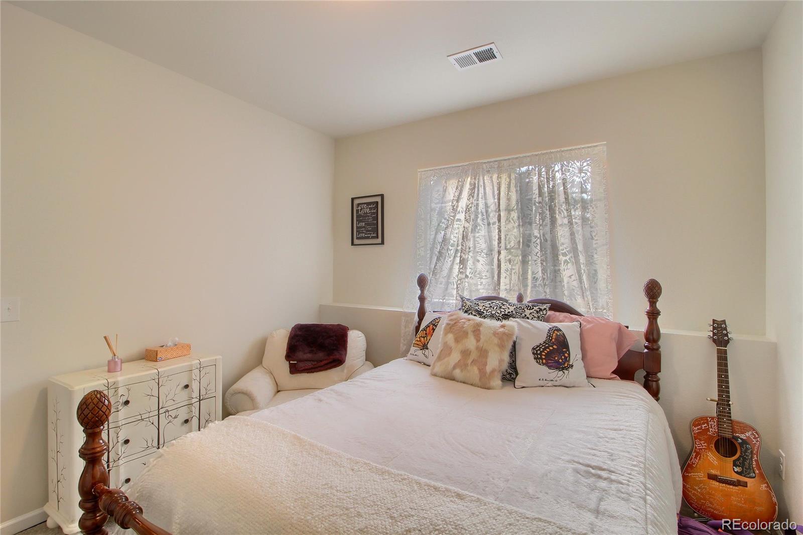 1335 South Chambers Road, Unit 101 Aurora, CO 80017 - Photo 28 of 40 a bedroom with a bed and a window