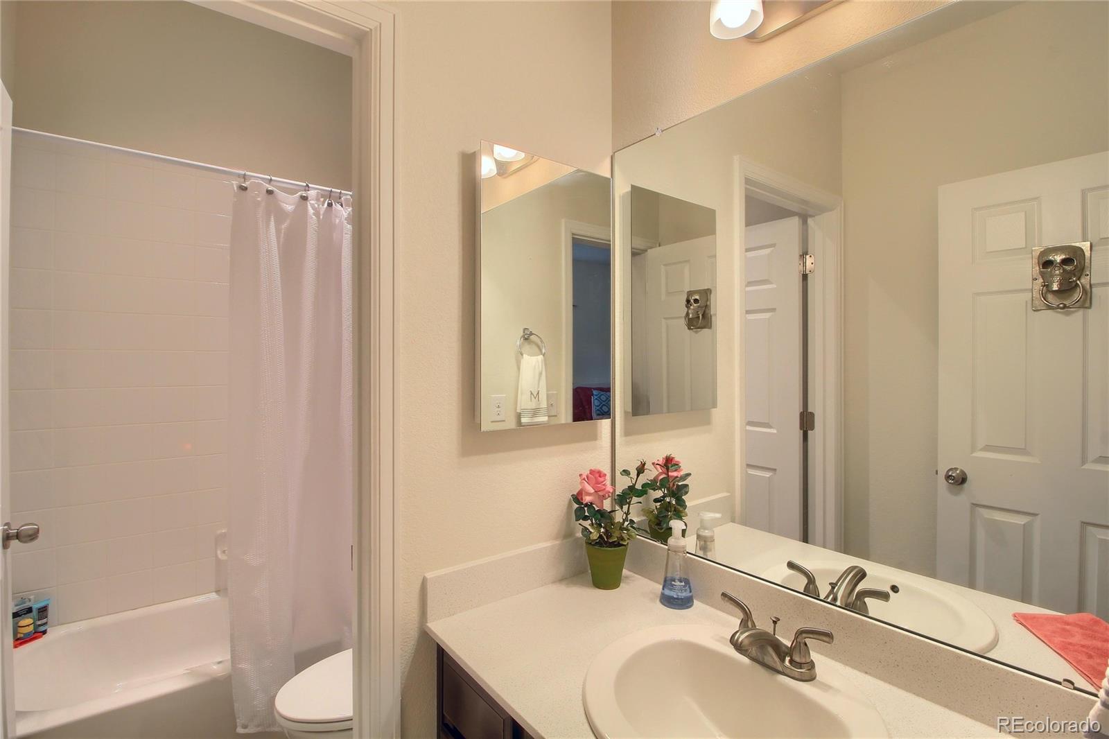 1335 South Chambers Road, Unit 101 Aurora, CO 80017 - Photo 30 of 40 a bathroom with a sink toilet and shower