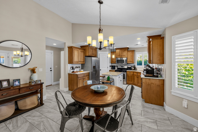 564 Spring Meadow Lane Farmington, UT 84025 - Photo 10 of 31 Vaulted ceiling, tile flooring, wood cabinetry, stainless steel appliances, and white plantation shutters