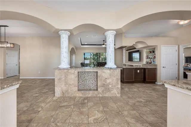 a view of a kitchen with a sink and a living room area