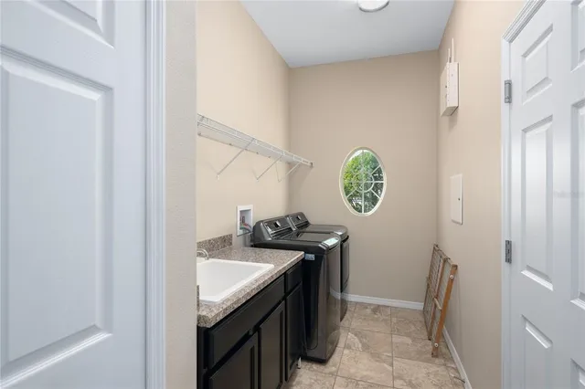 a utility room with window washer and dryer