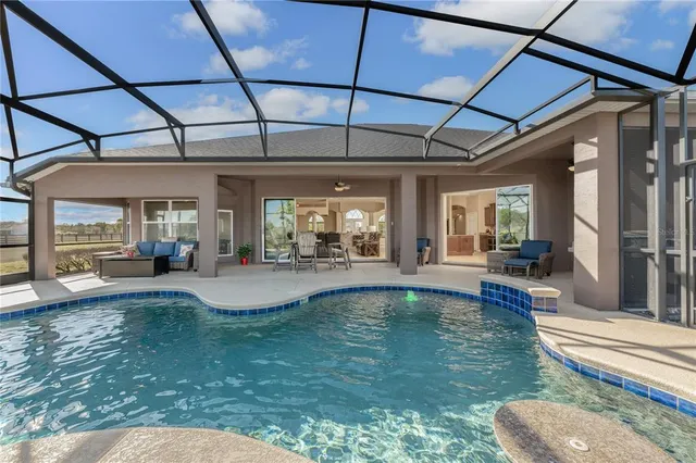 a view of a swimming pool with a yard