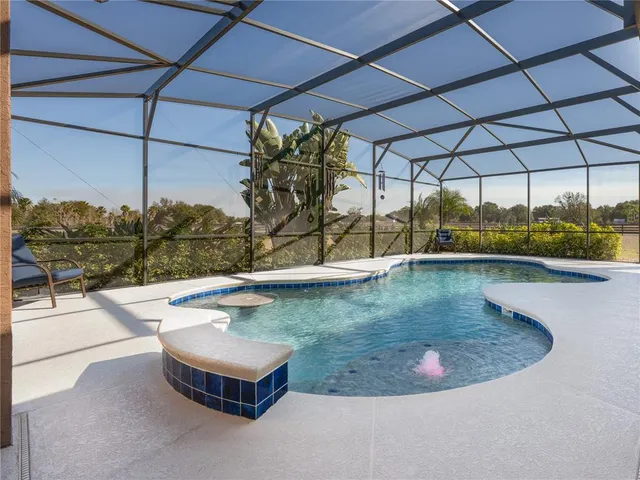a kitchen with a stove a counter space dining table and chairs