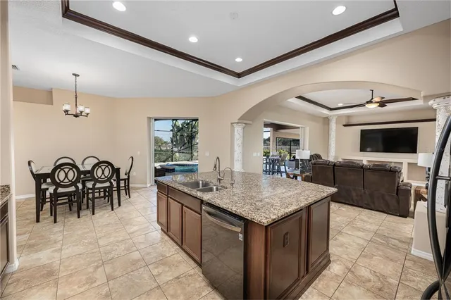 a kitchen with a dining table chairs cabinets and stainless steel appliances