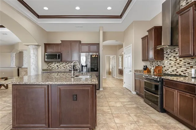 a bedroom with bed and a chandelier