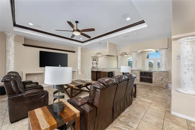 a living room with furniture a ceiling fan and a rug