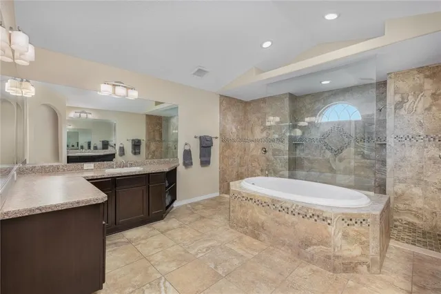 a bathroom with a double vanity sink toilet and shower