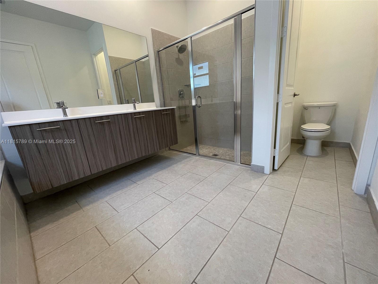 4506 Southwest 174th Avenue, Unit 4506 Miramar, FL 33029 - Photo 17 of 80 a bathroom with a granite countertop sink and a toilet