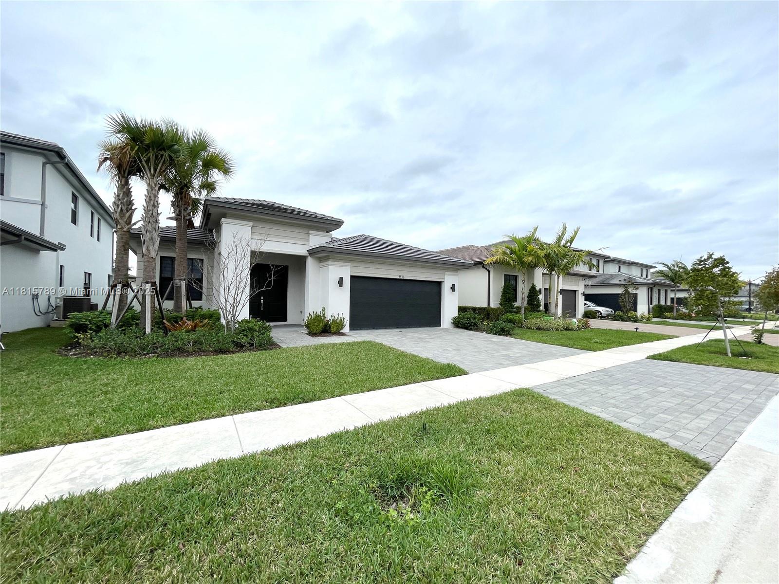 4506 Southwest 174th Avenue, Unit 4506 Miramar, FL 33029 - Photo 2 of 80 a front view of a house with a yard and garage