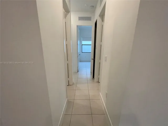 a view of an empty room and a window