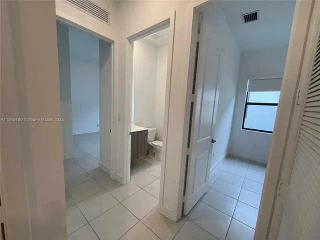 a bath tub sitting next to a white toilet and vanity