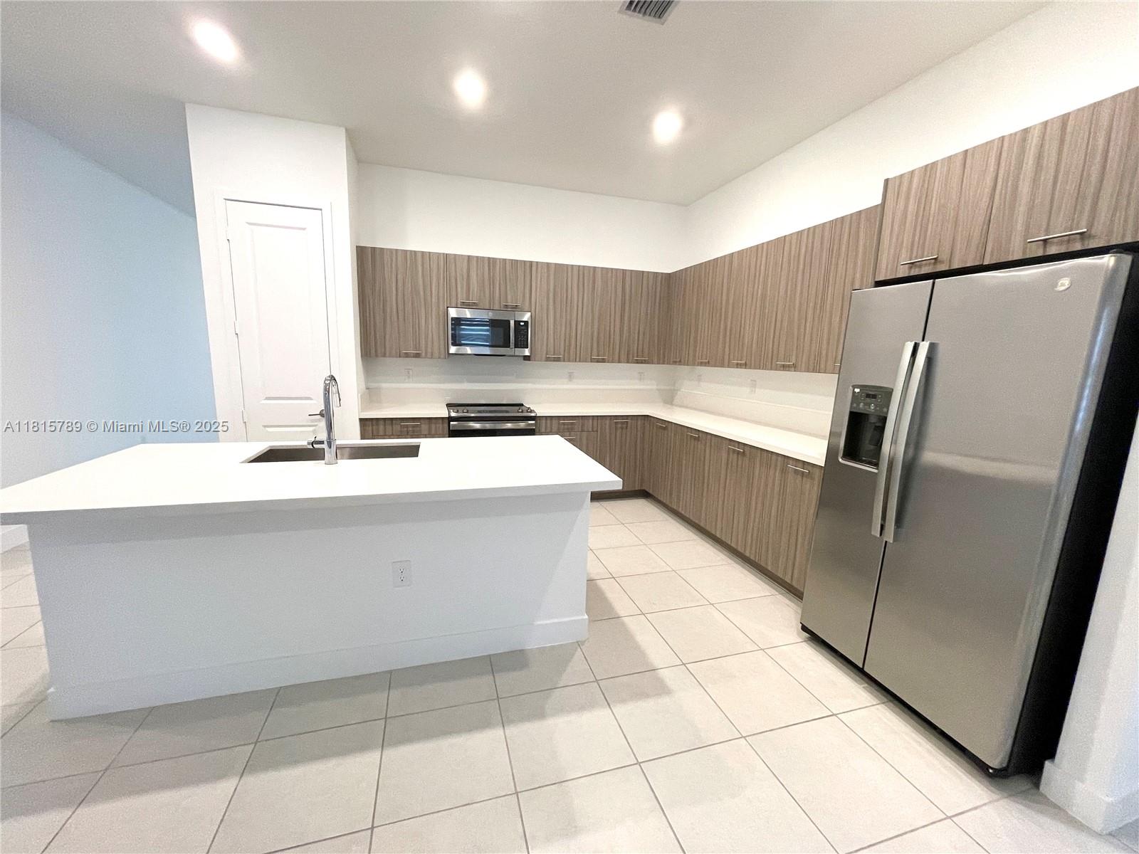 4506 Southwest 174th Avenue, Unit 4506 Miramar, FL 33029 - Photo 60 of 80 a kitchen with stainless steel appliances a refrigerator sink and microwave