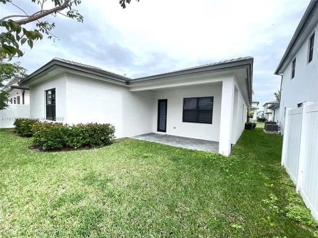 a backyard of a house with plants and a garden