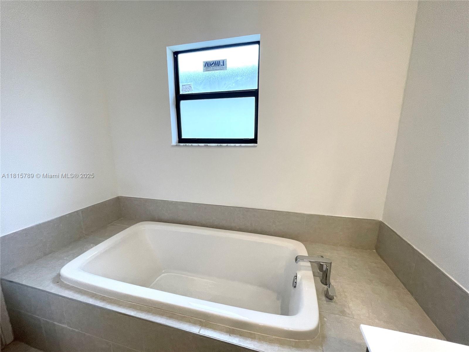 4506 Southwest 174th Avenue, Unit 4506 Miramar, FL 33029 - Photo 68 of 80 a bathroom with a bathtub