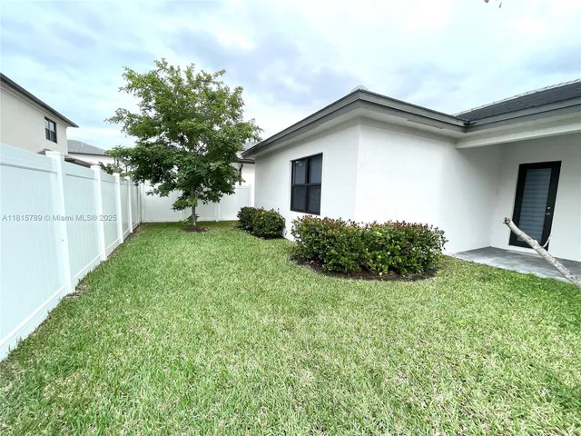 a view of backyard with a garden and plants