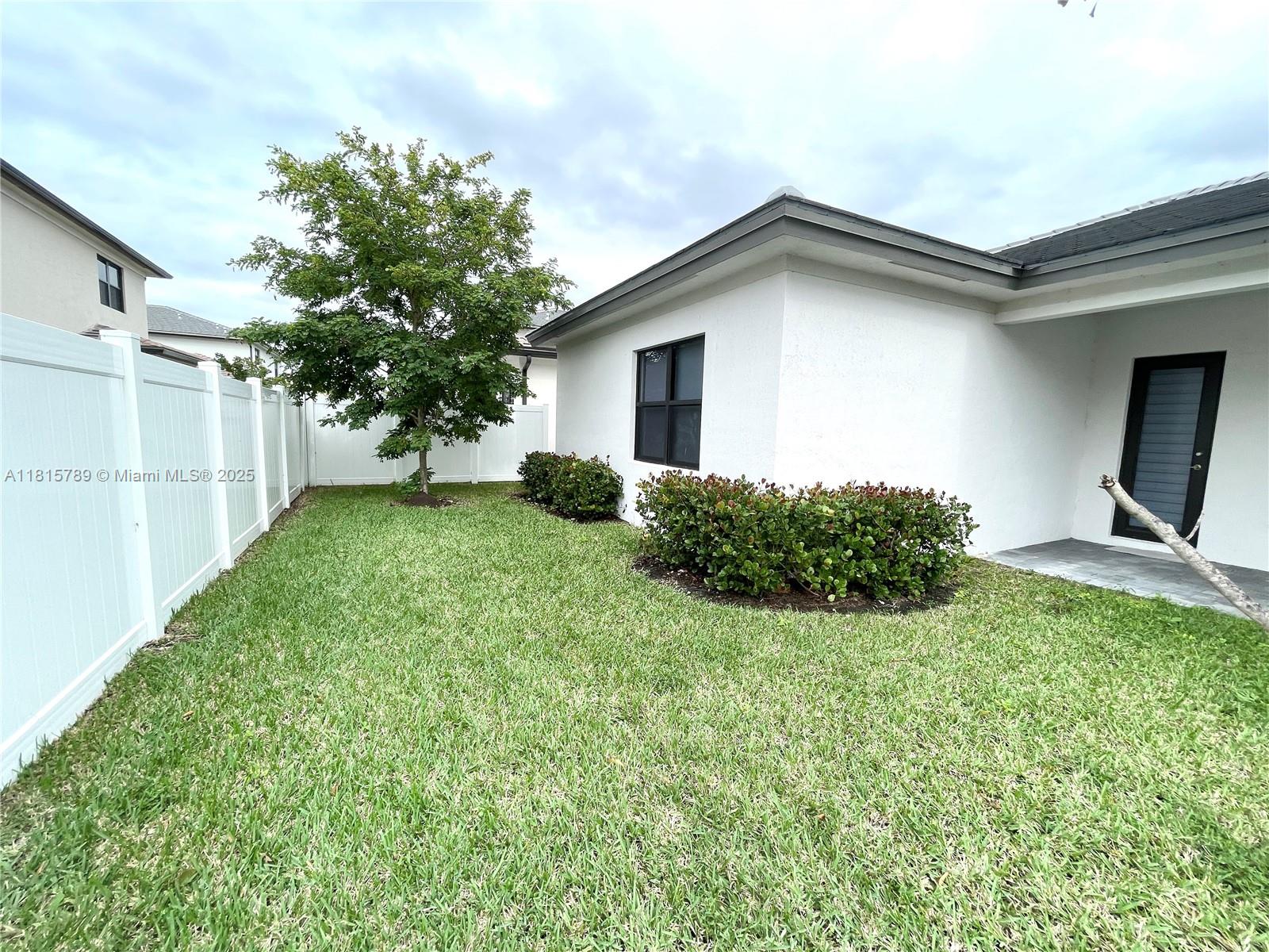 4506 Southwest 174th Avenue, Unit 4506 Miramar, FL 33029 - Photo 7 of 80 a backyard of a house with plants and a garden