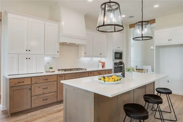 a kitchen with a sink cabinets and stainless steel appliances