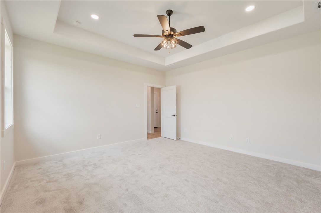 7888 Mathis Crk Drive Bryan, TX 77808 - Photo 19 of 41 Spare room featuring a raised ceiling, light colored carpet, a ceiling fan, and recessed lighting