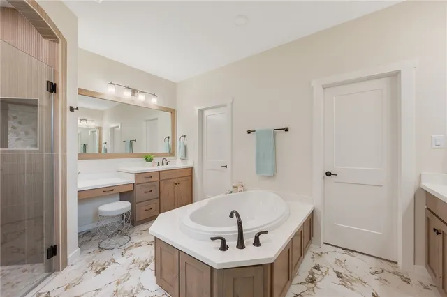 a bathroom with a bathtub shower sink and toilet