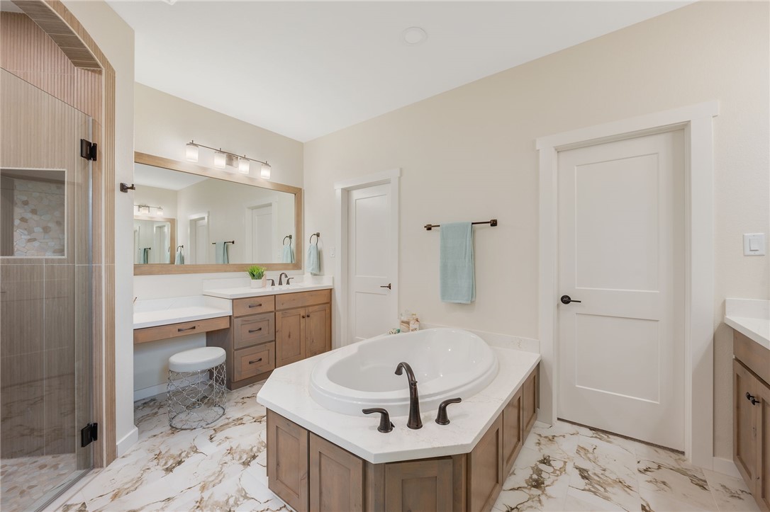 7888 Mathis Crk Drive Bryan, TX 77808 - Photo 21 of 41 Full bathroom with vanity, light marble finish flooring, a bath, and a shower stall