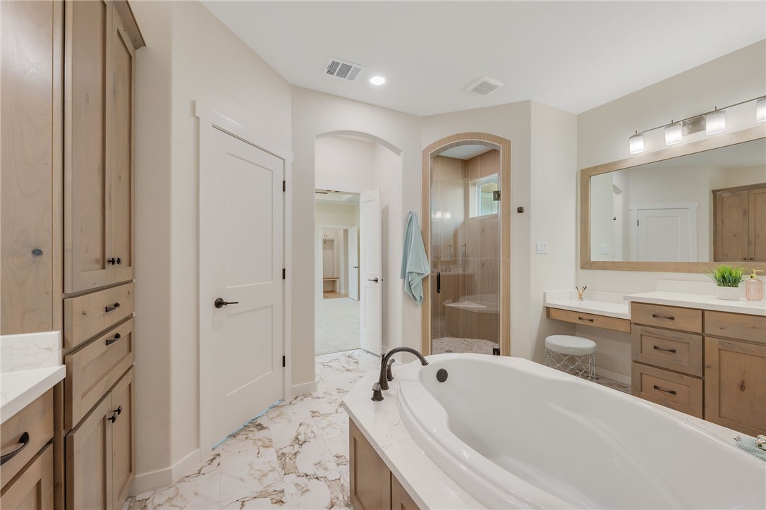 7888 Mathis Crk Drive Bryan, TX 77808 - Photo 22 of 41 Full bathroom featuring a shower stall, vanity, a garden tub, recessed lighting, and light marble finish floors