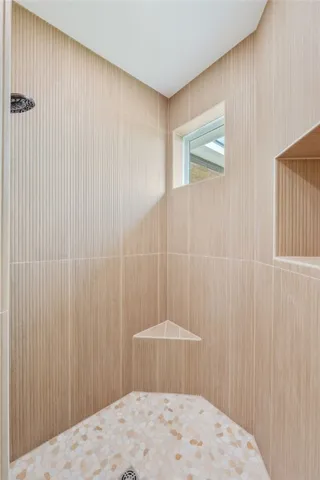 a bedroom with a bed and a curtain