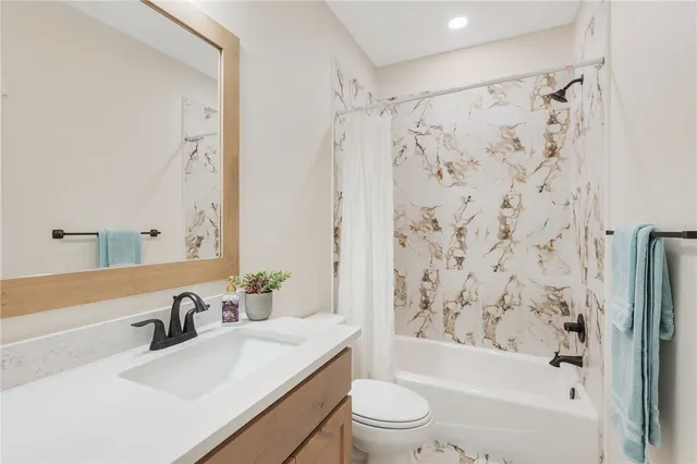 a bathroom with a sink a toilet and a bathtub