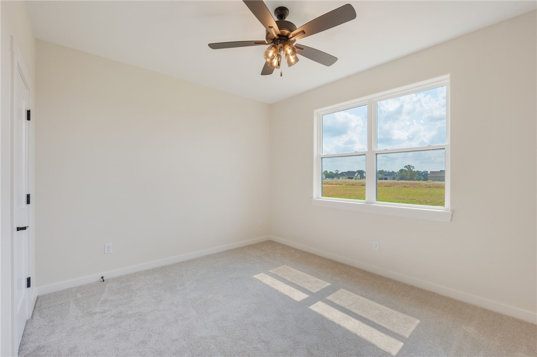 7888 Mathis Crk Drive Bryan, TX 77808 - Photo 28 of 41 Spare room featuring light carpet and ceiling fan