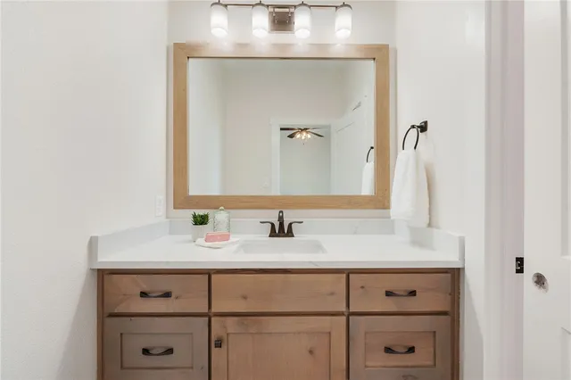 a bathroom with a sink vanity and a mirror