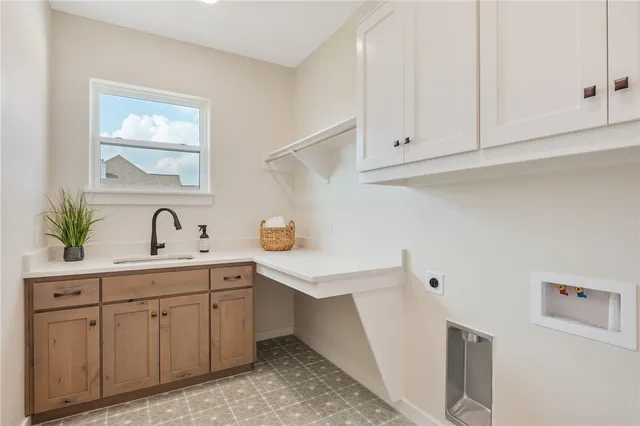 a view of cabinets a sink and dishwasher in a white cabinet
