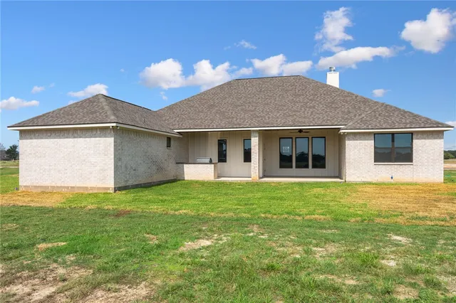 a view of a house with a backyard