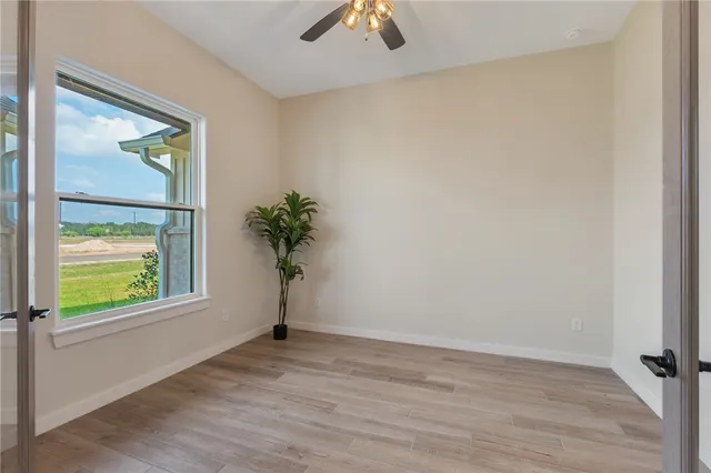 wooden floor in an empty room with a window