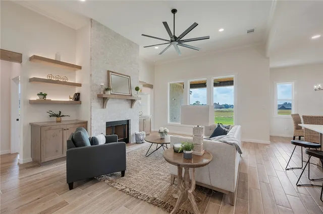 a living room with furniture fireplace and window