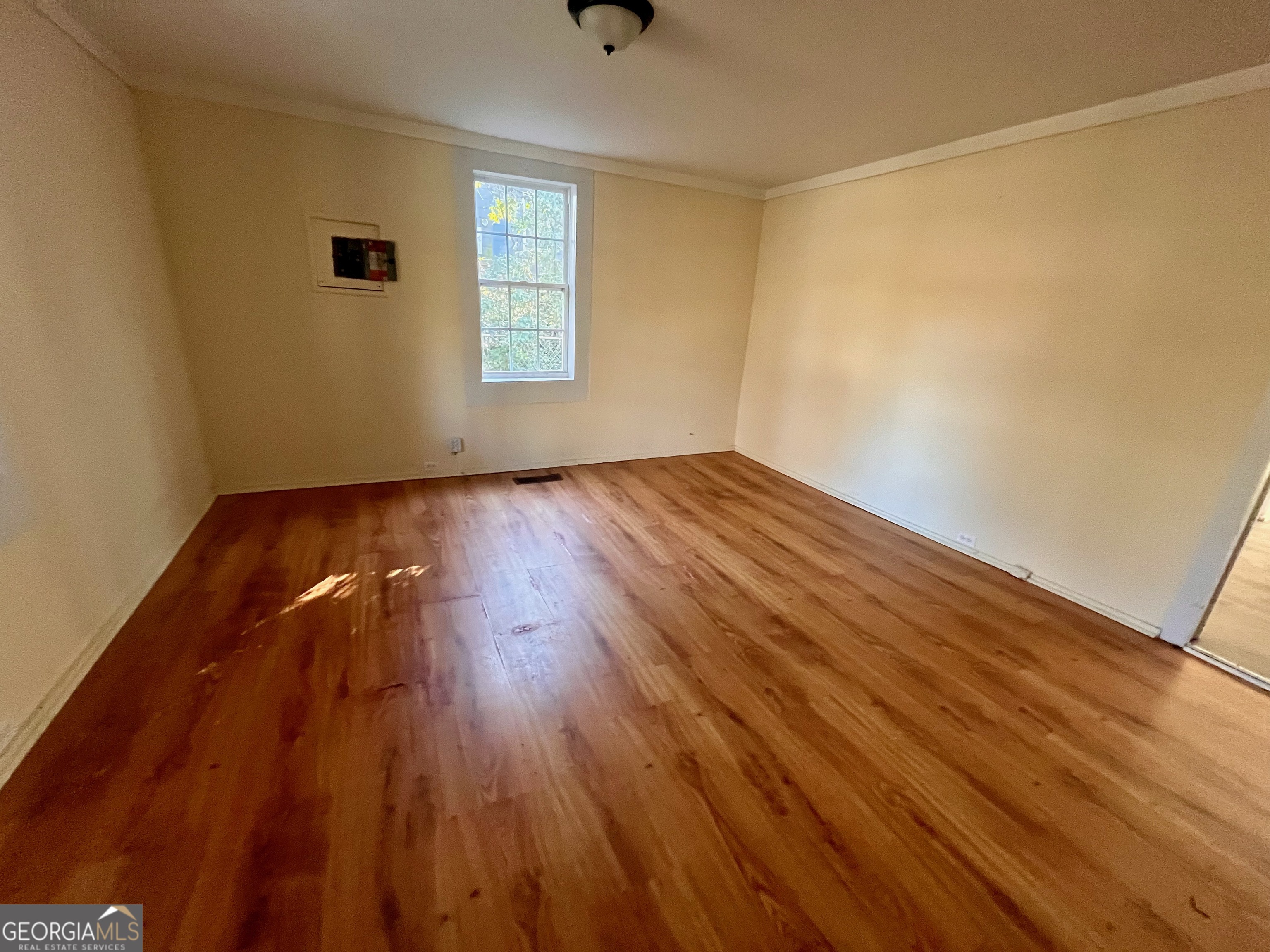 1202 Juniper Street LaGrange, GA 30240 - Photo 14 of 15 an empty room with wooden floor and windows