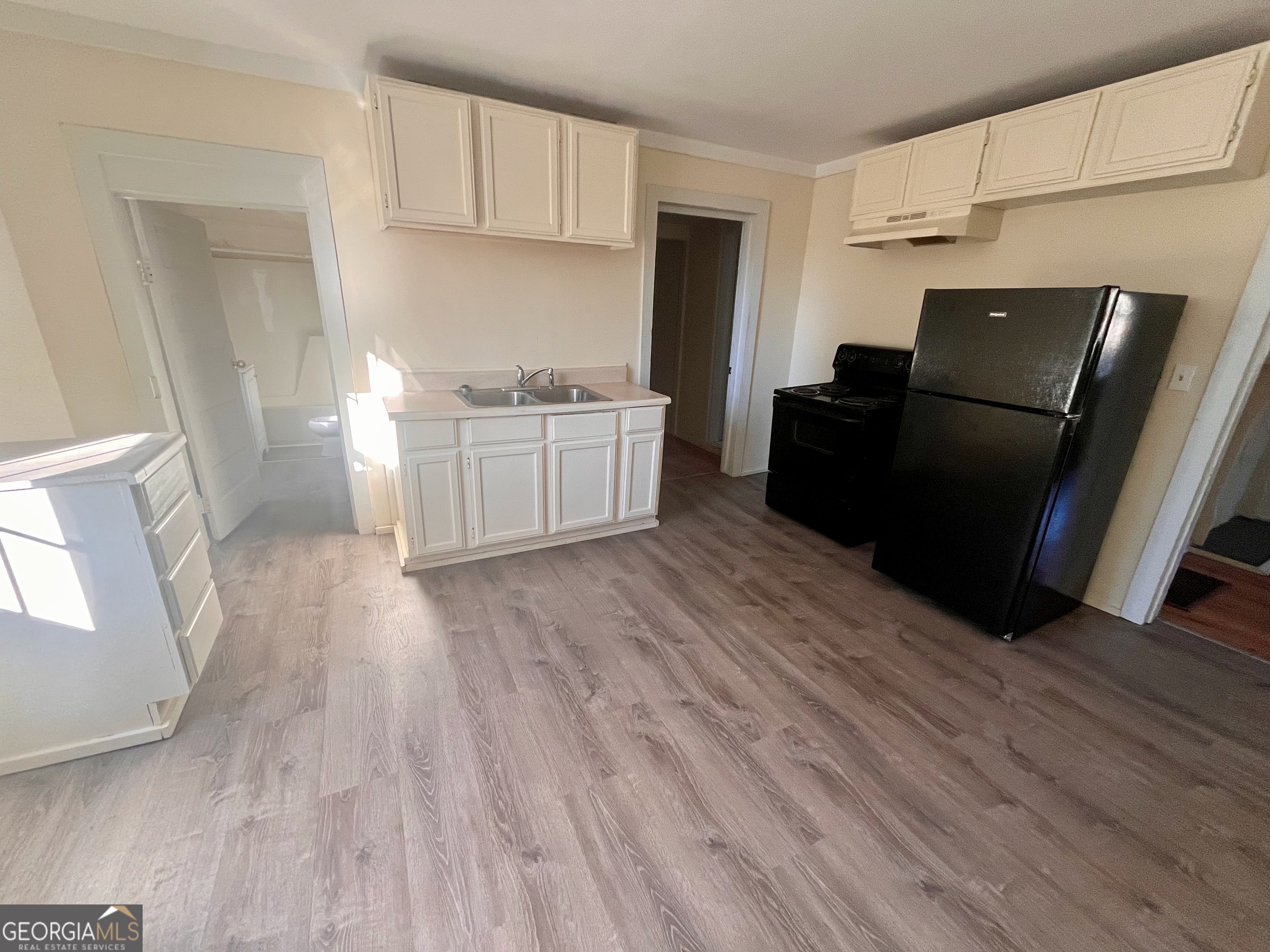 1202 Juniper Street LaGrange, GA 30240 - Photo 3 of 15 a view of kitchen with wooden floor and black appliances