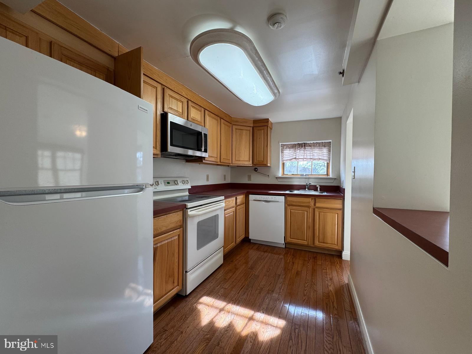 714 West Avenue, Unit 2 Jenkintown, PA 19046 - Photo 10 of 19 a kitchen with stainless steel appliances granite countertop a stove a sink dishwasher a refrigerator and a microwave oven with wooden floor