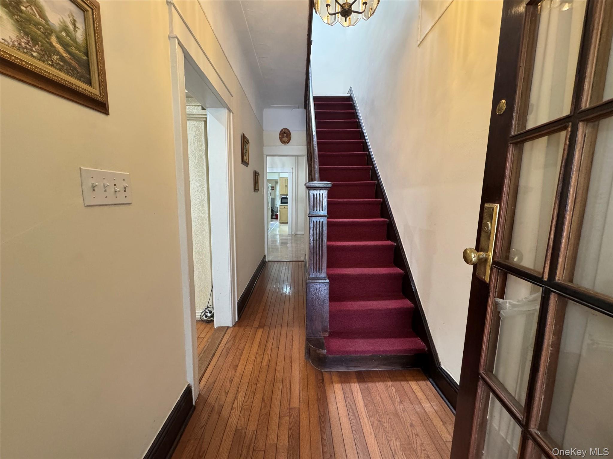 80-58 88th Road Queens, NY 11421 - Photo 9 of 21 a view of a hallway with wooden floor and staircase