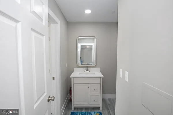 a bathroom with a sink toilet and mirror
