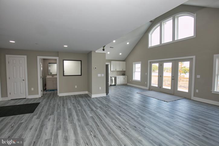 27068 Annie Hyland Road Princess Anne, MD 21853 - Photo 3 of 12 an empty room with wooden floor and a fireplace
