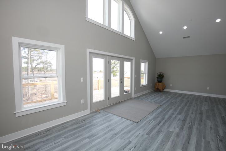 27068 Annie Hyland Road Princess Anne, MD 21853 - Photo 6 of 12 a view of an empty room with a window and wooden floor