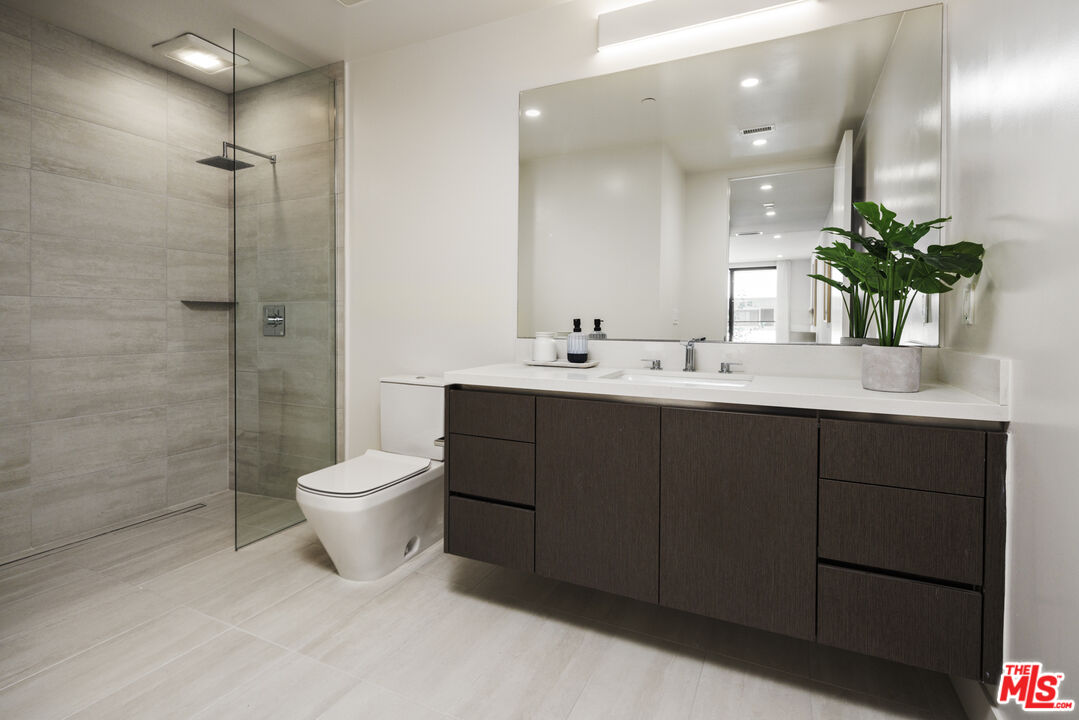 411 South Hamel Road, Unit 106 Los Angeles, CA 90048 - Photo 11 of 17 a bathroom with a double vanity sink toilet and shower
