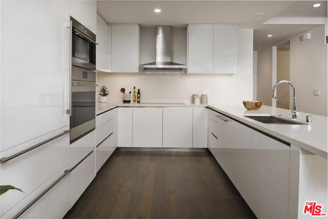 411 South Hamel Road, Unit 106 Los Angeles, CA 90048 - Photo 2 of 17 a kitchen with granite countertop a sink stainless steel appliances and cabinets