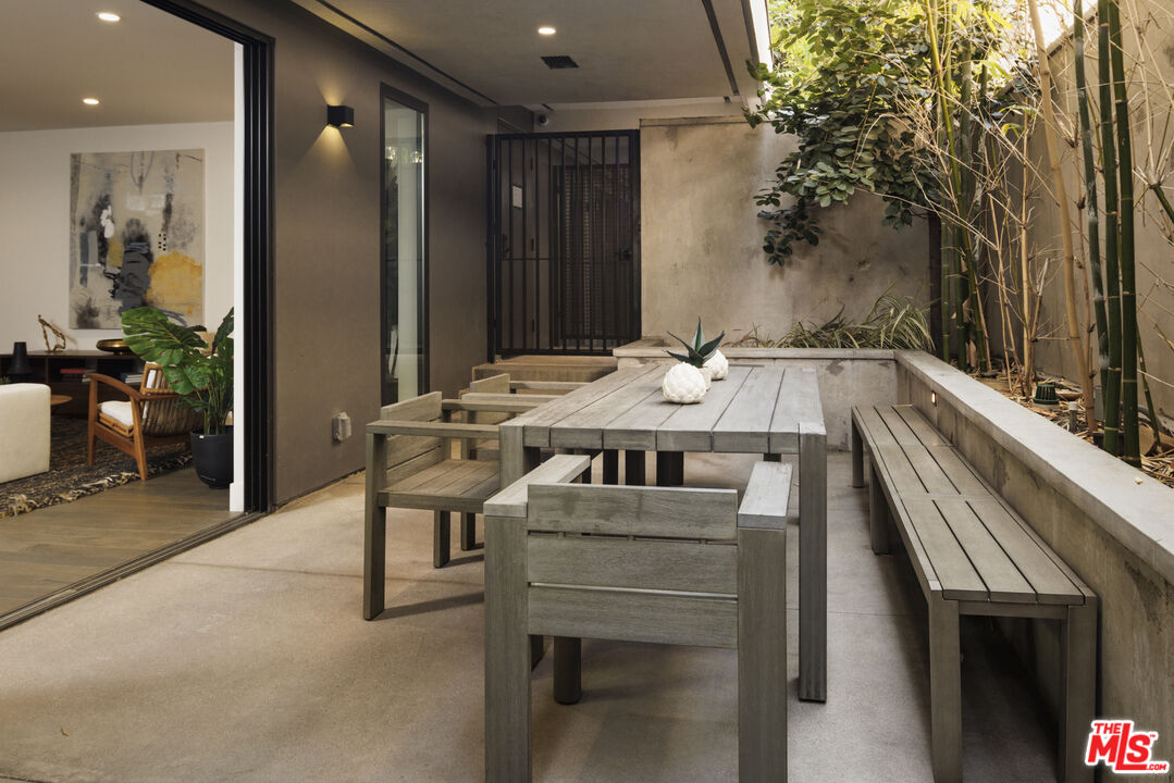 411 South Hamel Road, Unit 106 Los Angeles, CA 90048 - Photo 5 of 17 a dinning table and chairs in a balcony