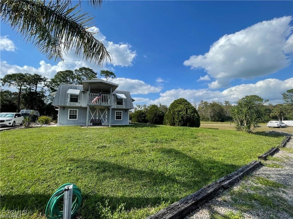 19790 Burgundy Farms Road Estero, FL 33928 - Photo 3 of 12 a view of a house with a big yard and potted plants