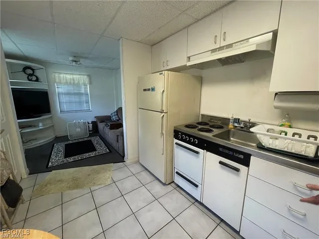 a kitchen with granite countertop a stove and a refrigerator