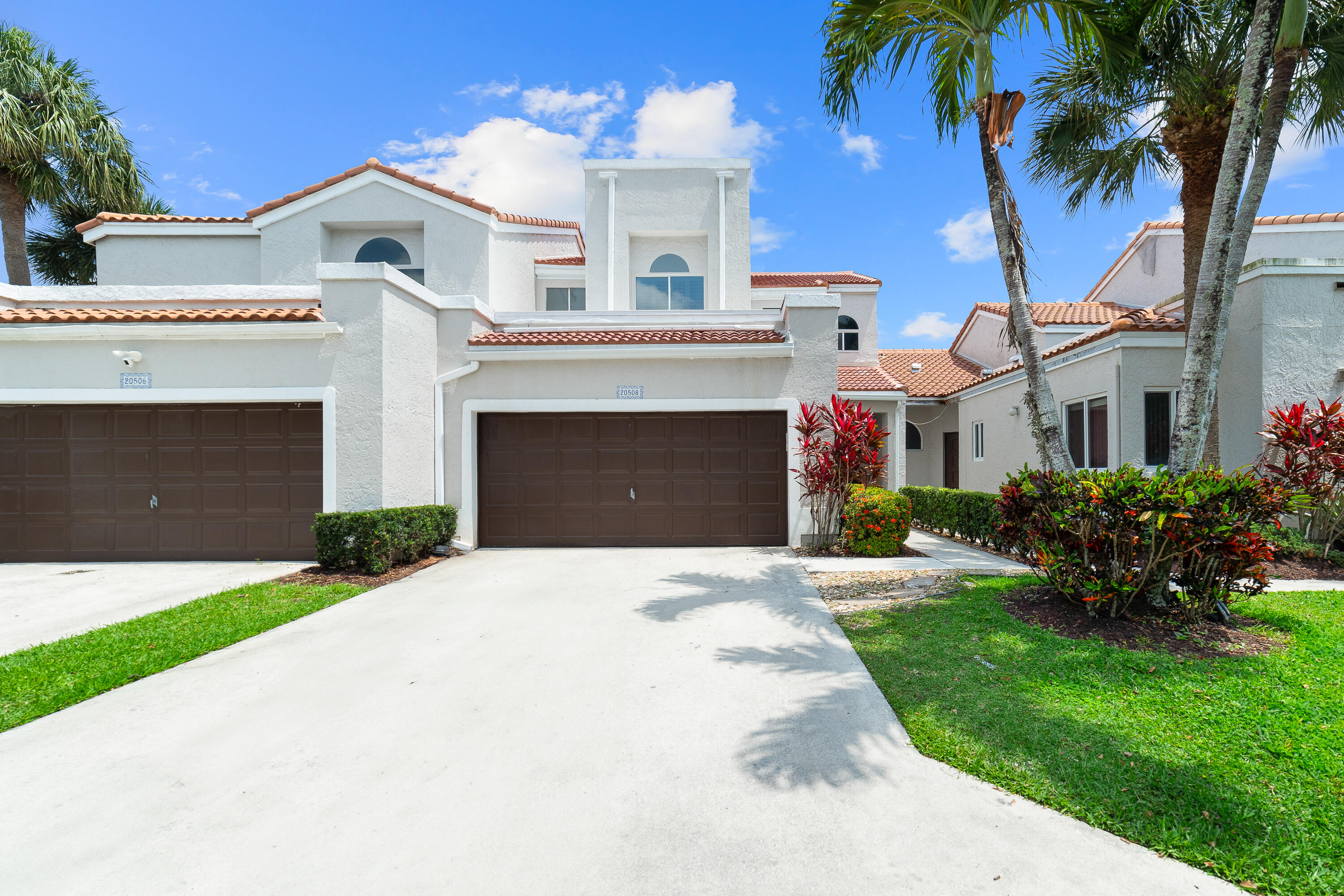 20508 Vía Marisa Boca Raton, FL 33498 - Photo 5 of 31 a front view of a house with a garden and a yard