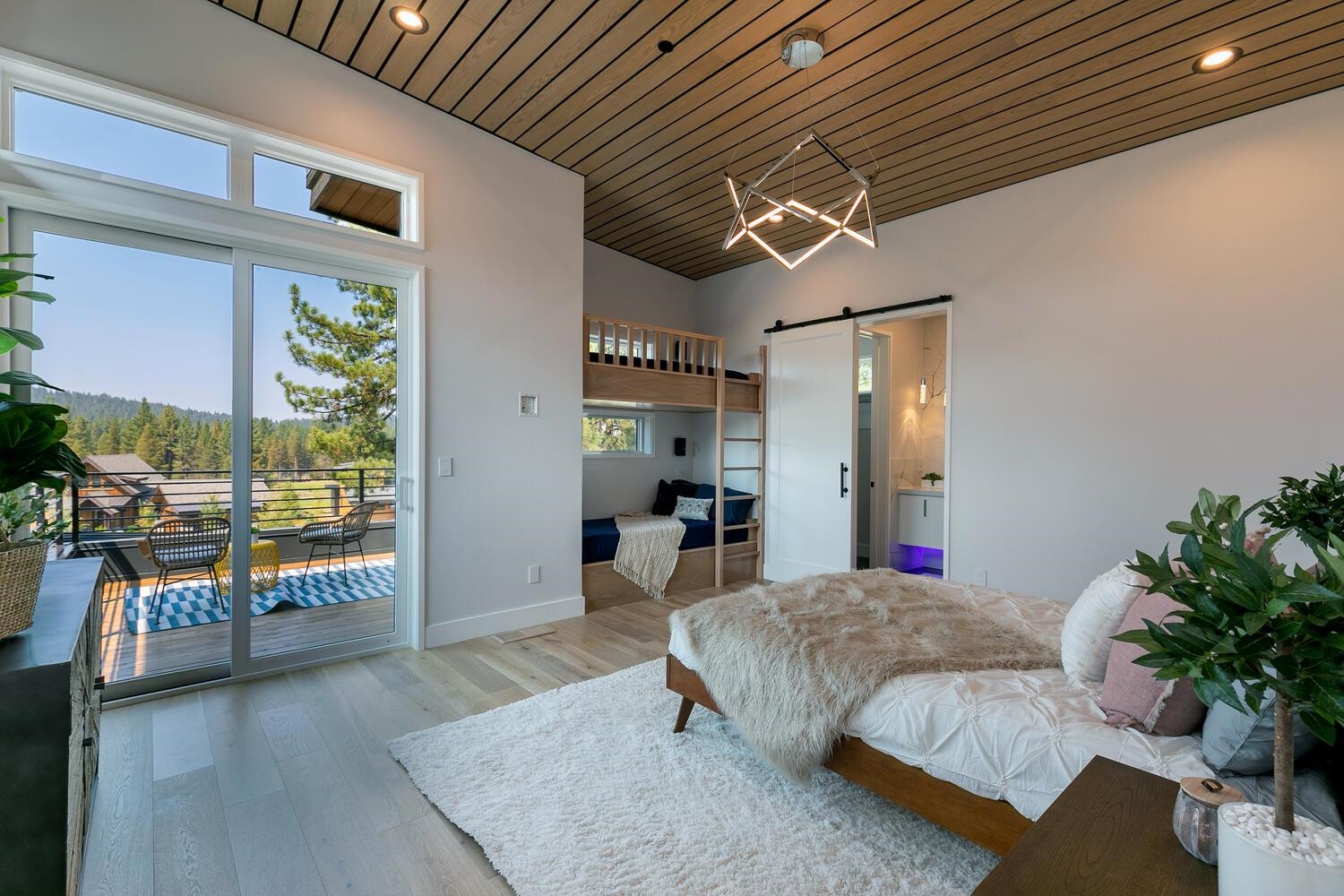 11614 Henness Road Truckee, CA 96161 - Photo 11 of 21 a bed room with a bed and a chandelier