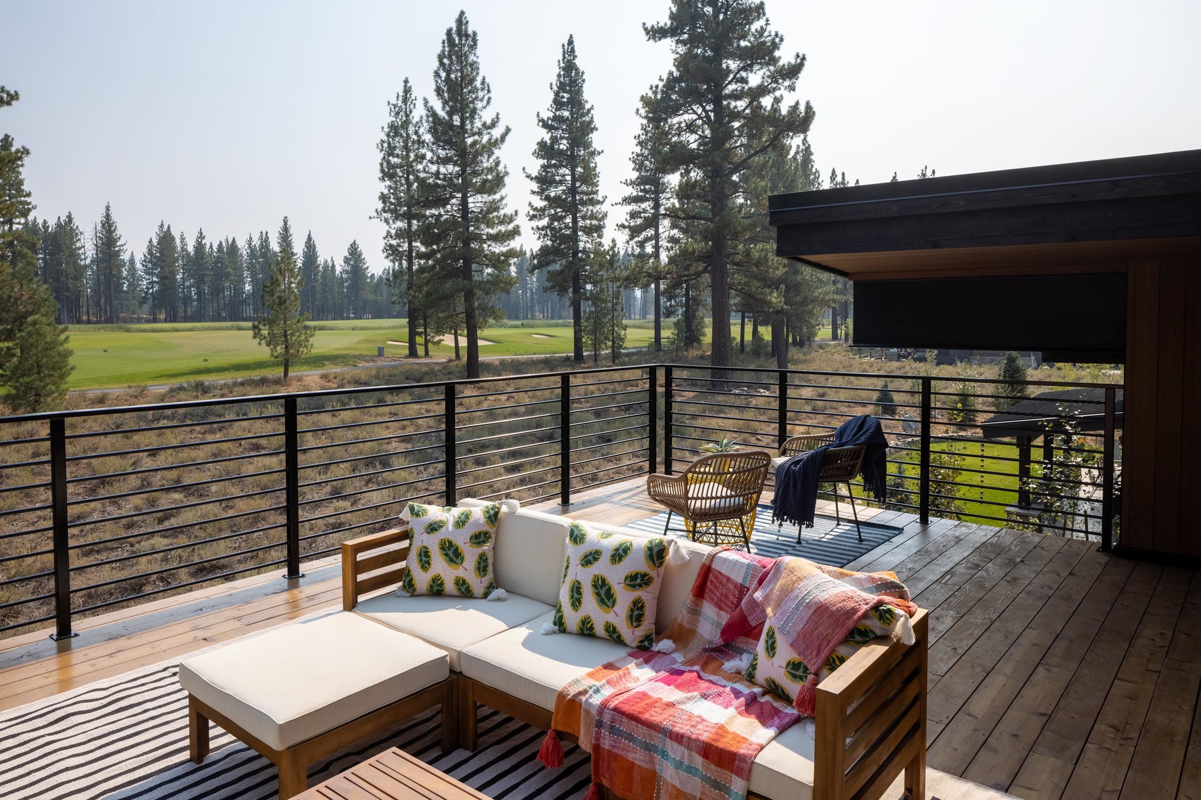 11614 Henness Road Truckee, CA 96161 - Photo 16 of 21 a view of a patio with couches table and chairs with wooden floor and fence
