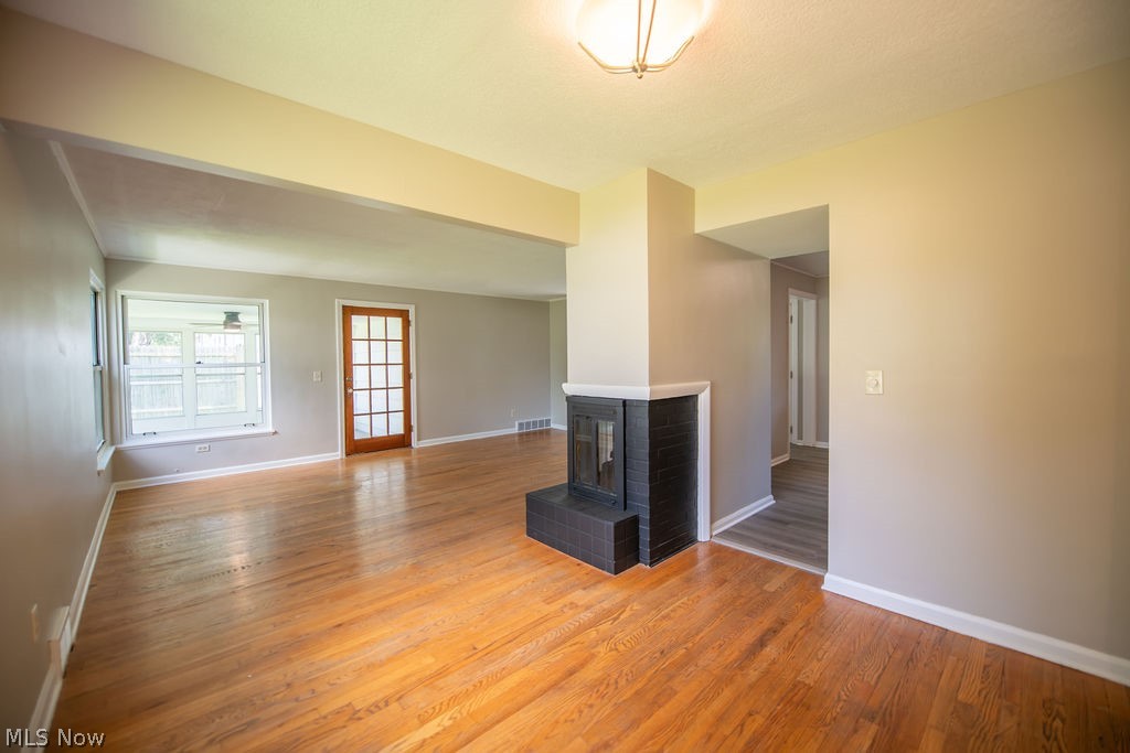 4221 2nd Street Northwest Canton, OH 44708 - Photo 8 of 35 Living room view featuring a fireplace and an abundance of natural light.